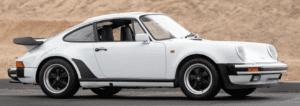 White classic sports car on a road.