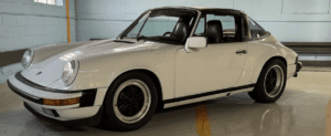 White vintage sports car in a garage.