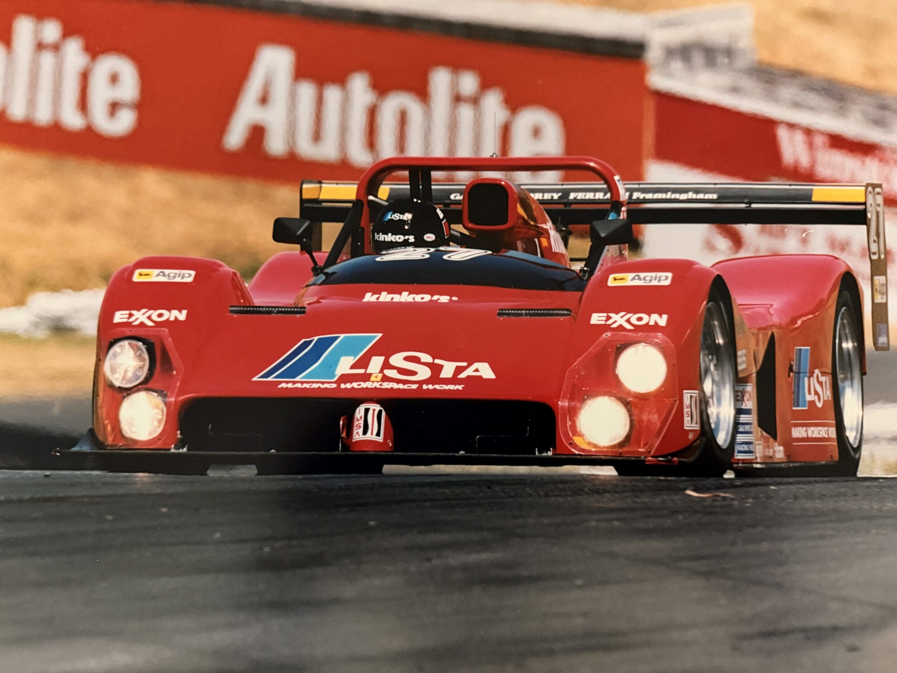 Red race car speeding on track.