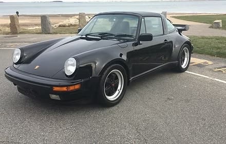 Black vintage sports car by the beach