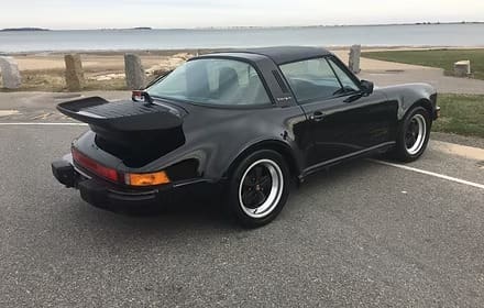 Black classic sports car by the sea