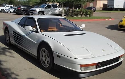 Vintage white coupe in parking lot