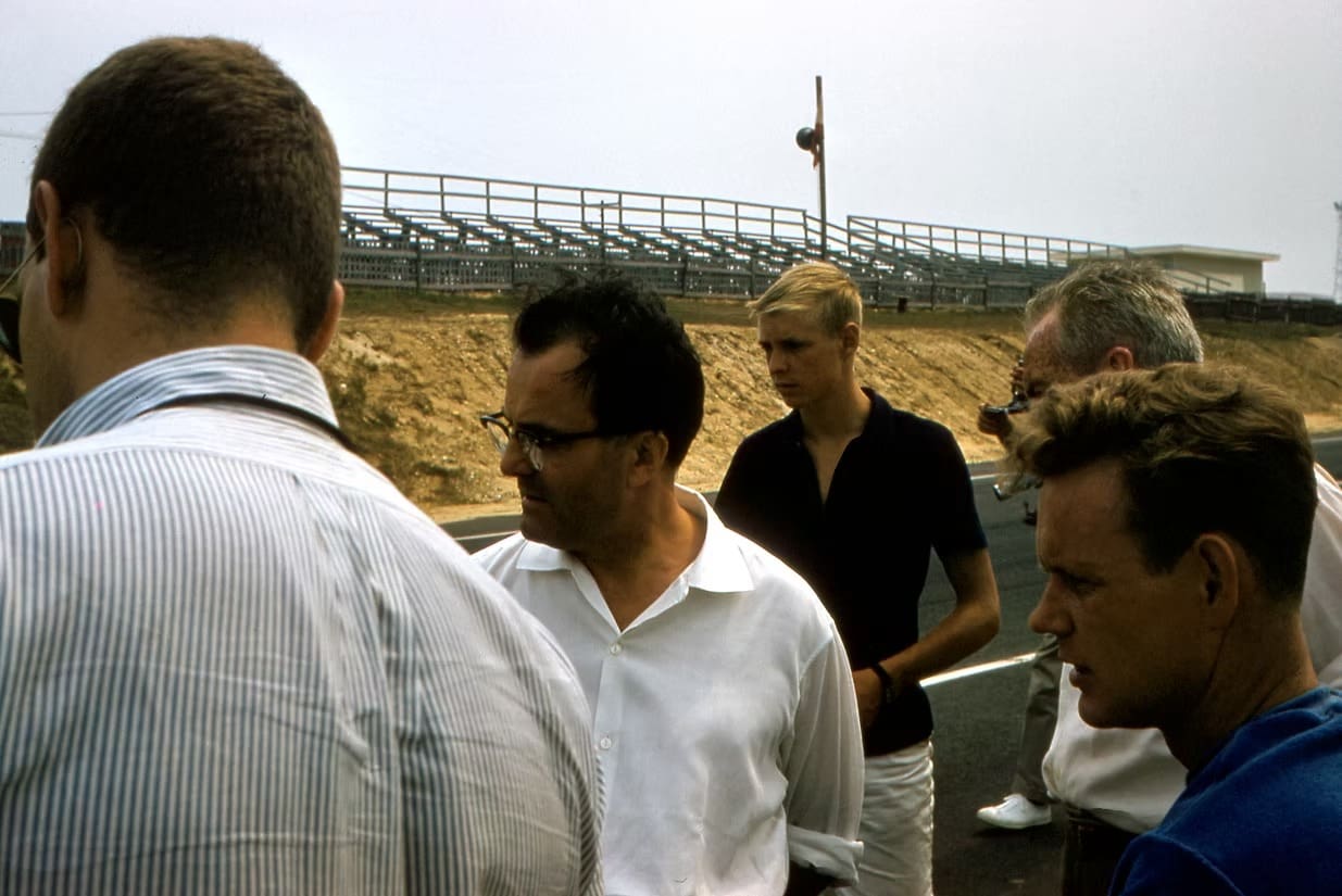 Men standing near a racetrack