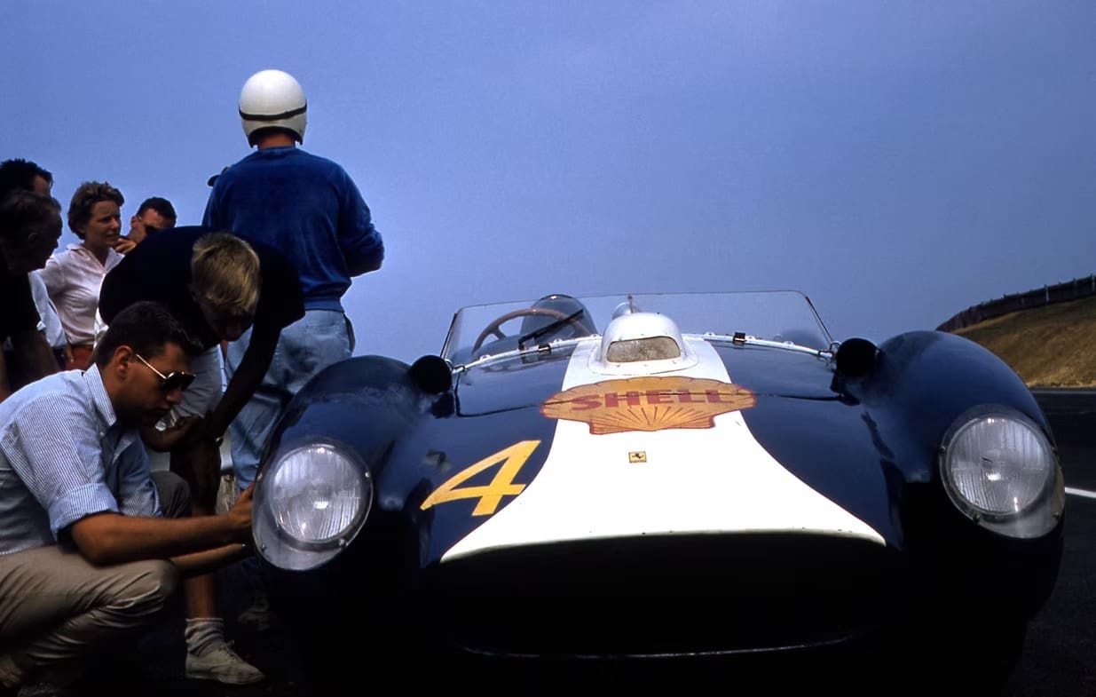 Classic car on racetrack with crowd