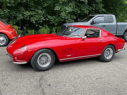 Retro sports car beside truck