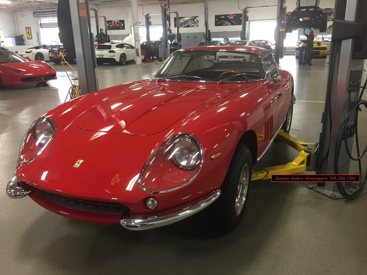 Vintage red car on lift