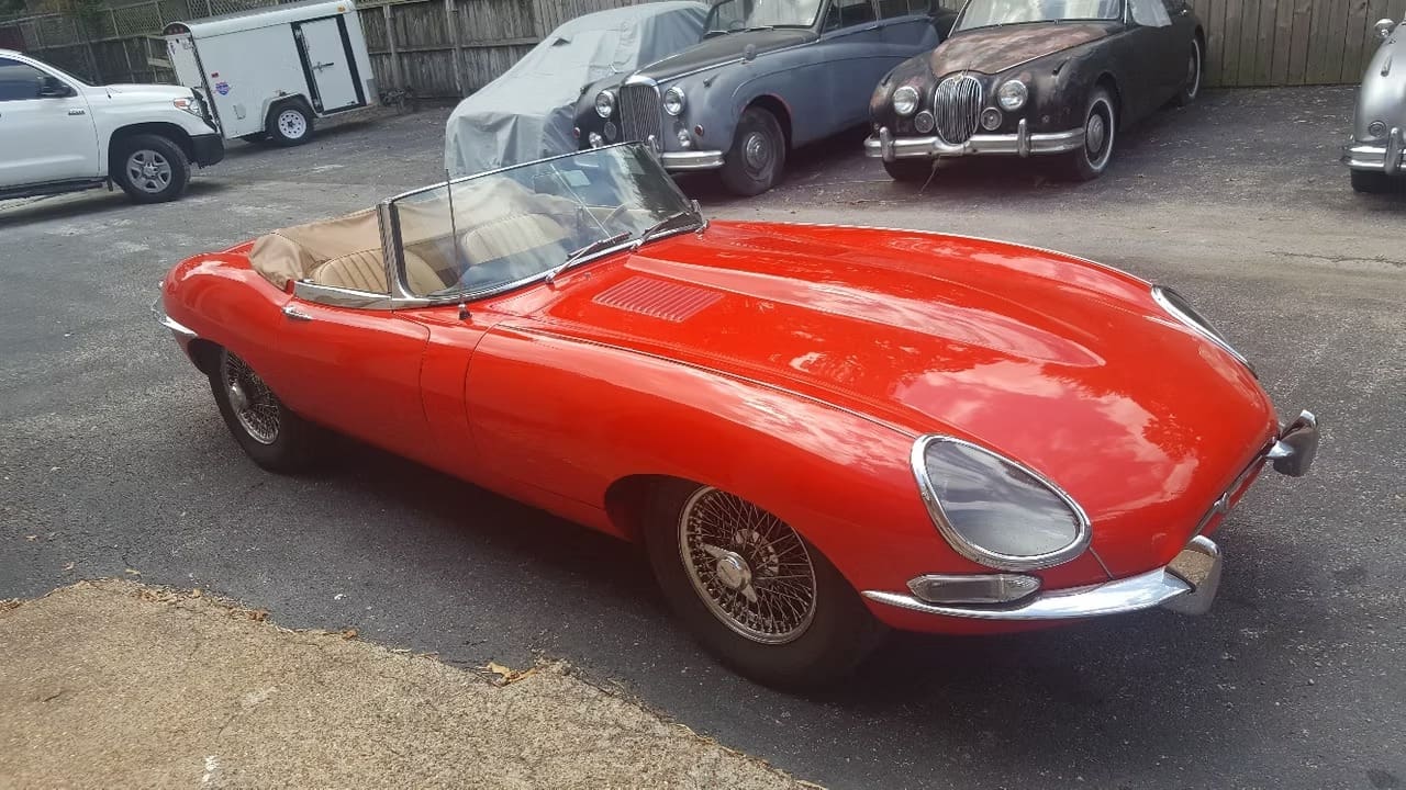 Red classic convertible car parked outside