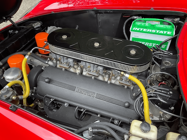 Classic car engine with yellow hoses