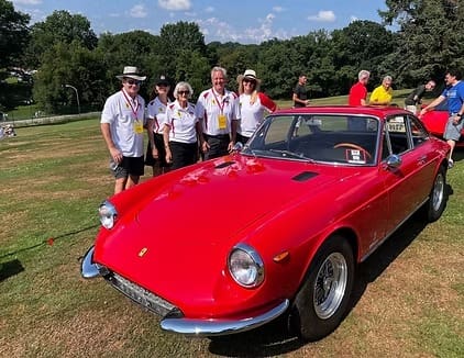 Red vintage car with group of people