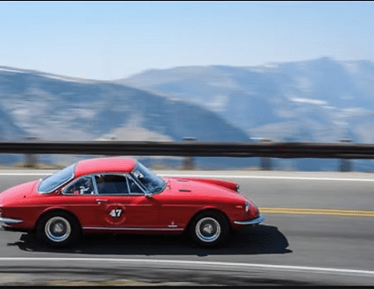 Vintage vehicle traveling along mountainous highway