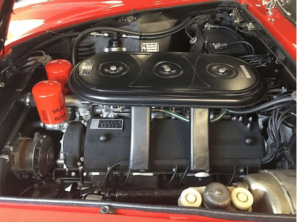 Retro car engine under open hood
