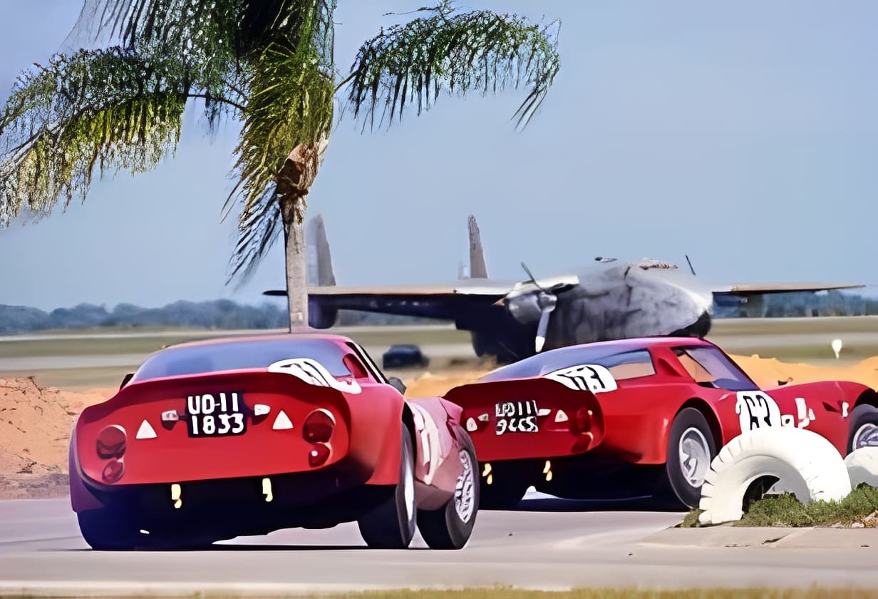 Classic cars racing near a parked airplane
