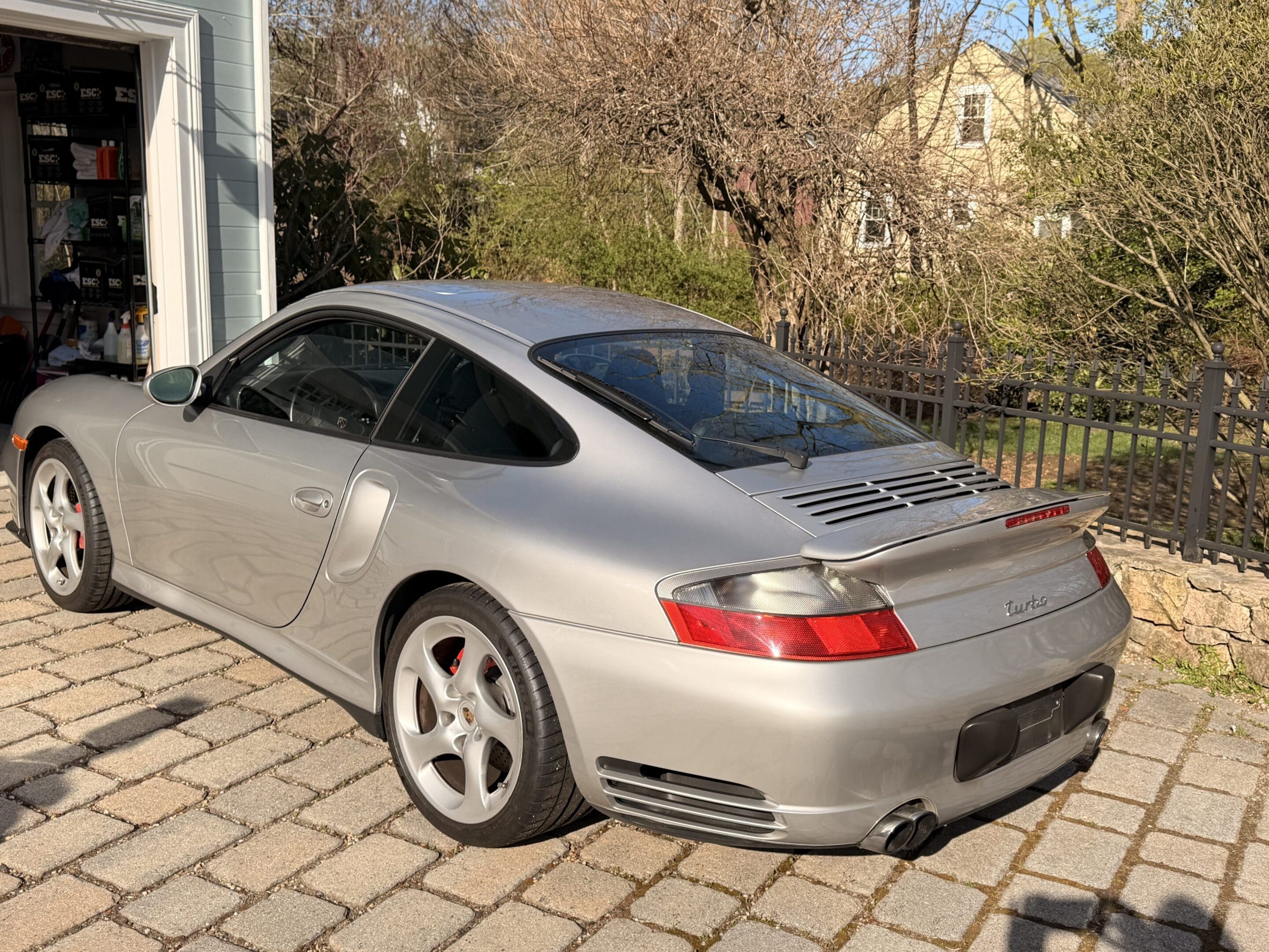 Silver Porsche 911 Carrera parked in driveway