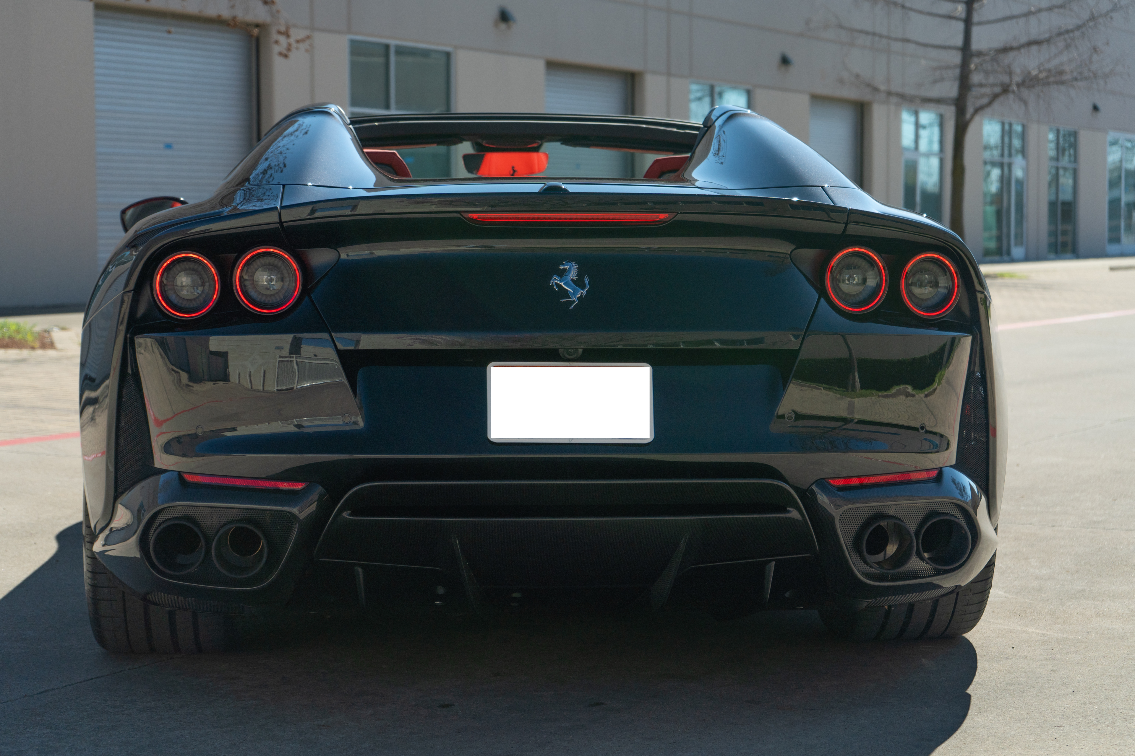 Rear view of dark green Ferrari convertible