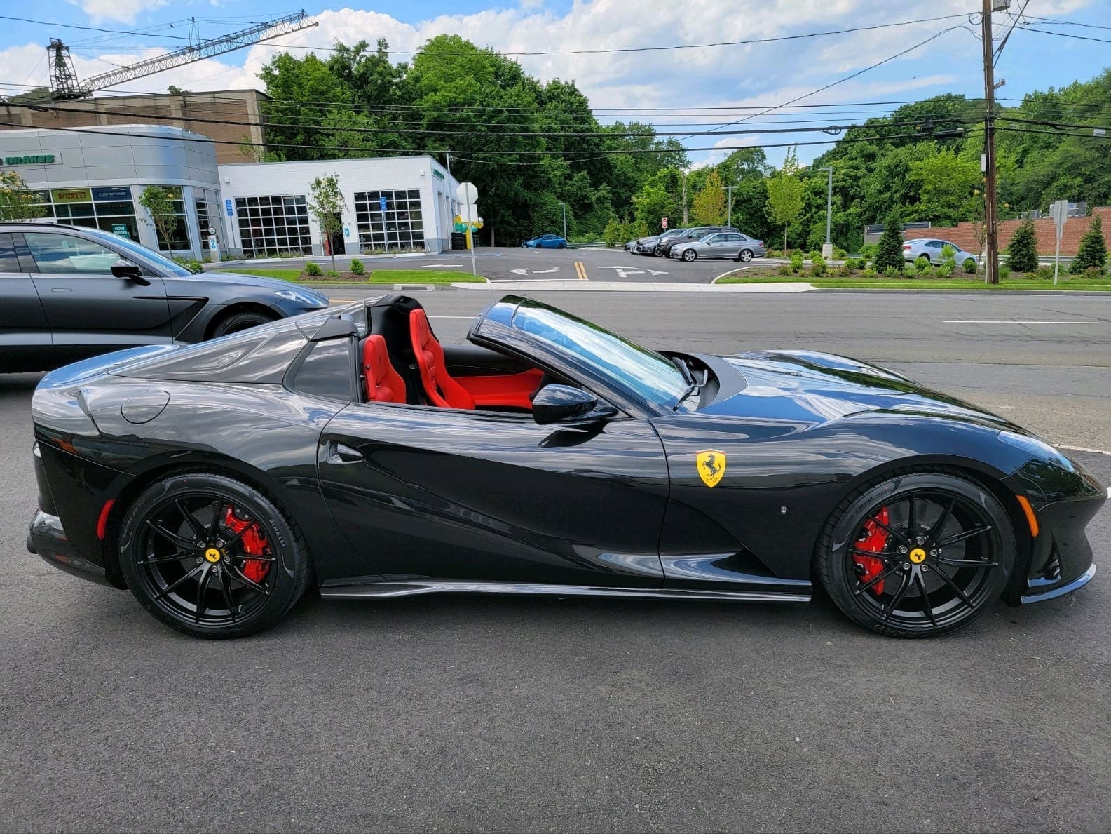 Black Ferrari convertible with red interior