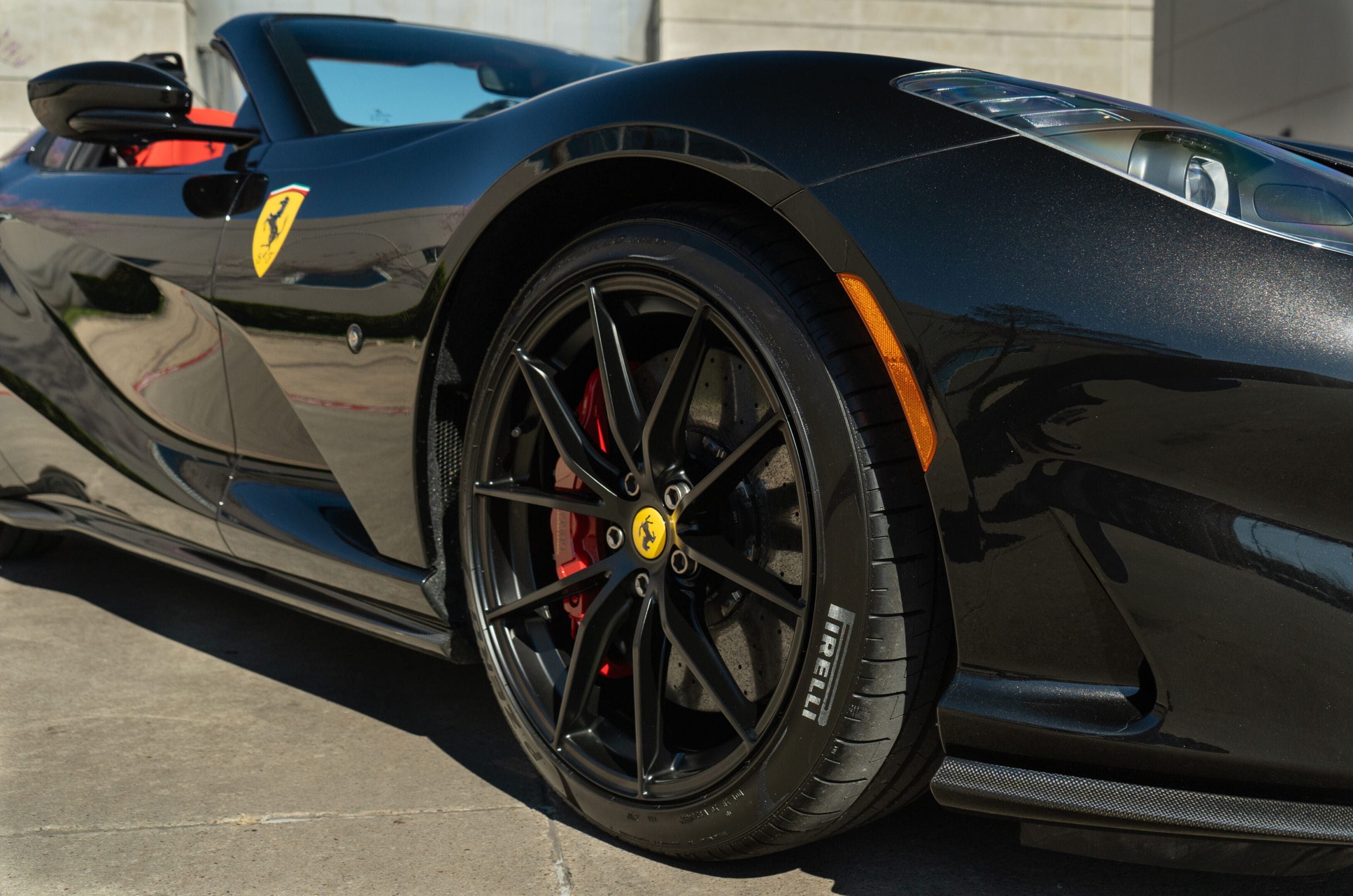 Close-up of black Ferrari convertible front wheel